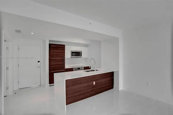 a spacious bathroom with a sink a vanity and mirror