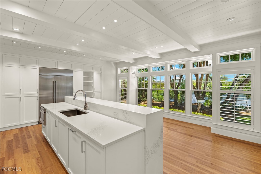 1517 Sand Castle Road Sanibel, FL 33957 - Photo 13 of 50 a kitchen with stainless steel appliances granite countertop a sink and a large window