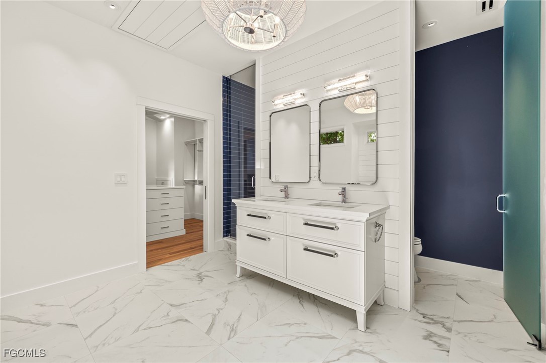 1517 Sand Castle Road Sanibel, FL 33957 - Photo 27 of 50 a bathroom with a sink vanity and a mirror