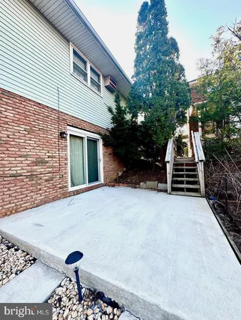 a view of a house with a yard and potted plants