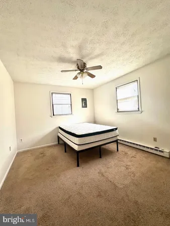 a living room with furniture and a ceiling fan