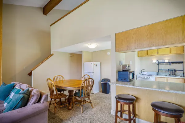 a view of a dining room with furniture and a table