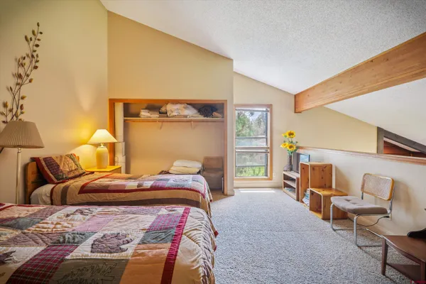 a bedroom with a bed and lamp