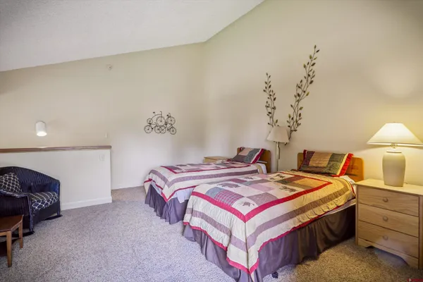 a bedroom with a bed and a lamp