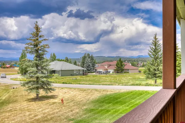 a view of a big yard with an outdoor seating