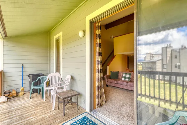 a balcony with table and chairs