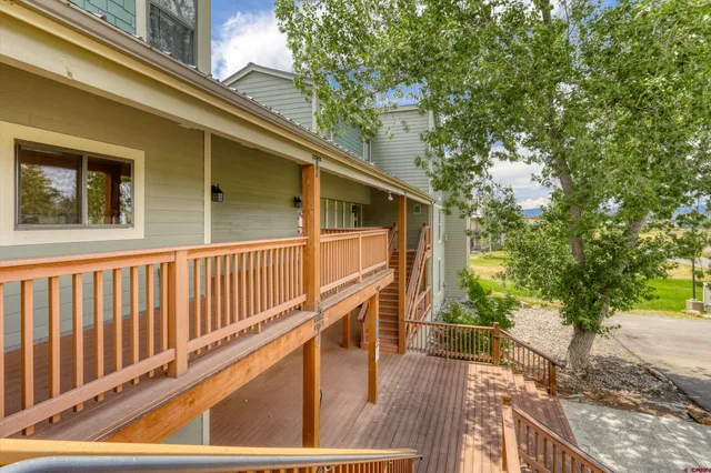a view of balcony with wooden floor and fence