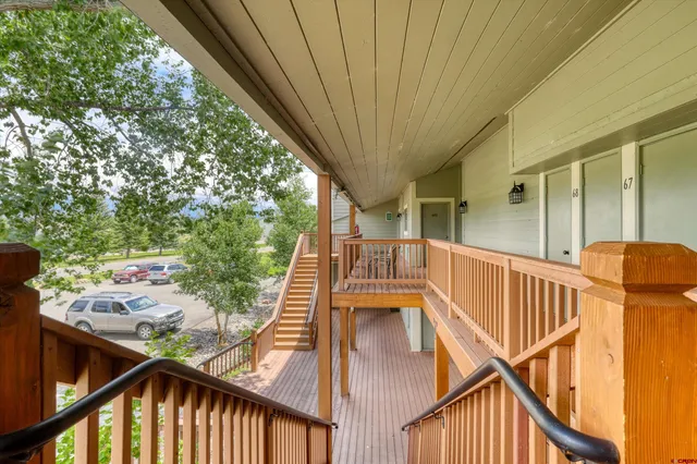 a view of balcony with wooden floor and outdoor seating
