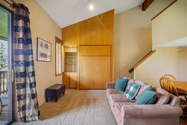 a living room with furniture and a entryway