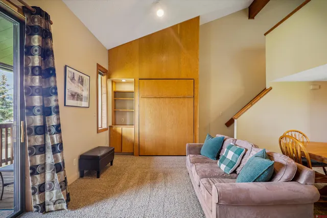 a living room with furniture and a entryway
