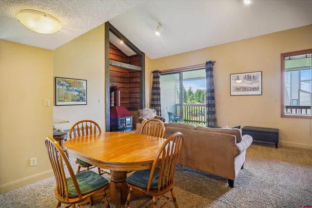 a view of a dining room with furniture and window