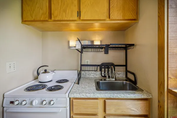 a kitchen with a stove and cabinets