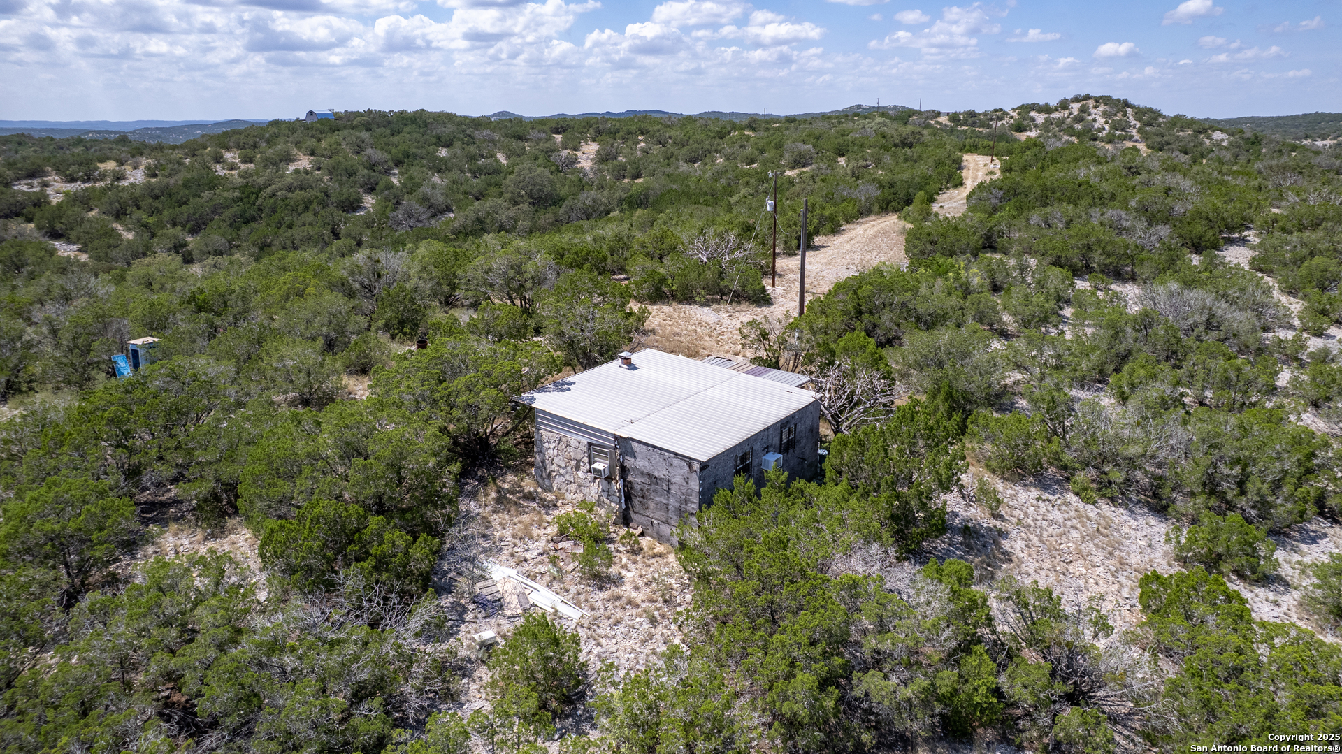 0 Bluff Creek Ranch Rocksprings, TX 78880 - Photo 2 of 21 an aerial view of a house with a yard and lake