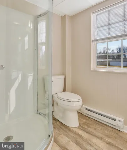 a white toilet sitting next to a bathroom sink