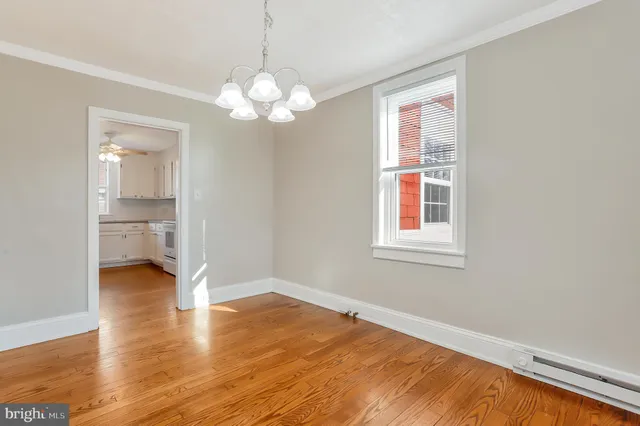 a view of a room with wooden floor and window