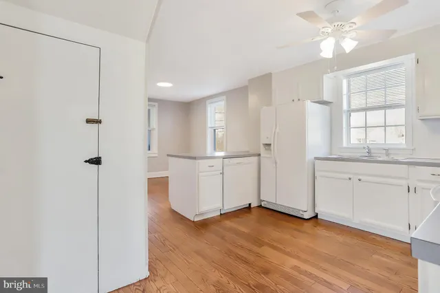 a view of a kitchen with wooden cabinet and a refrigerator