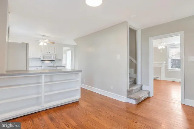 a view of kitchen with wooden floor and electronic appliances