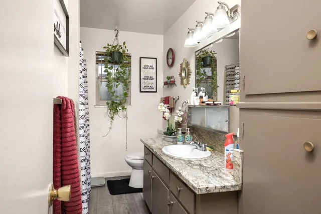 a bathroom with a granite countertop sink and a mirror