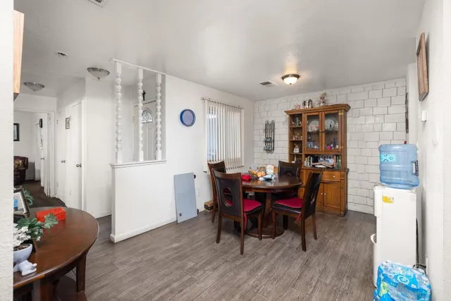 a view of a dining room with furniture and wooden floor