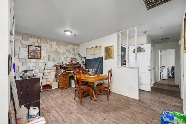 a workspace with wooden floor and furniture