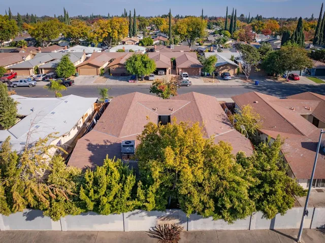 an aerial view of a houses with a yard