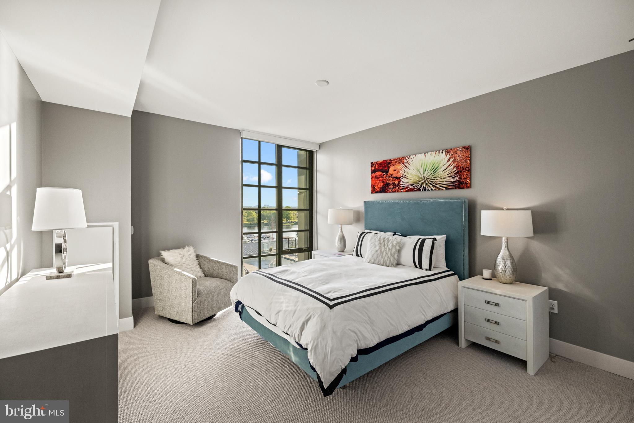 45 Sutton Square Southwest, Unit 503 Washington, DC 20024 - Photo 12 of 50 a bedroom with a bed and a window