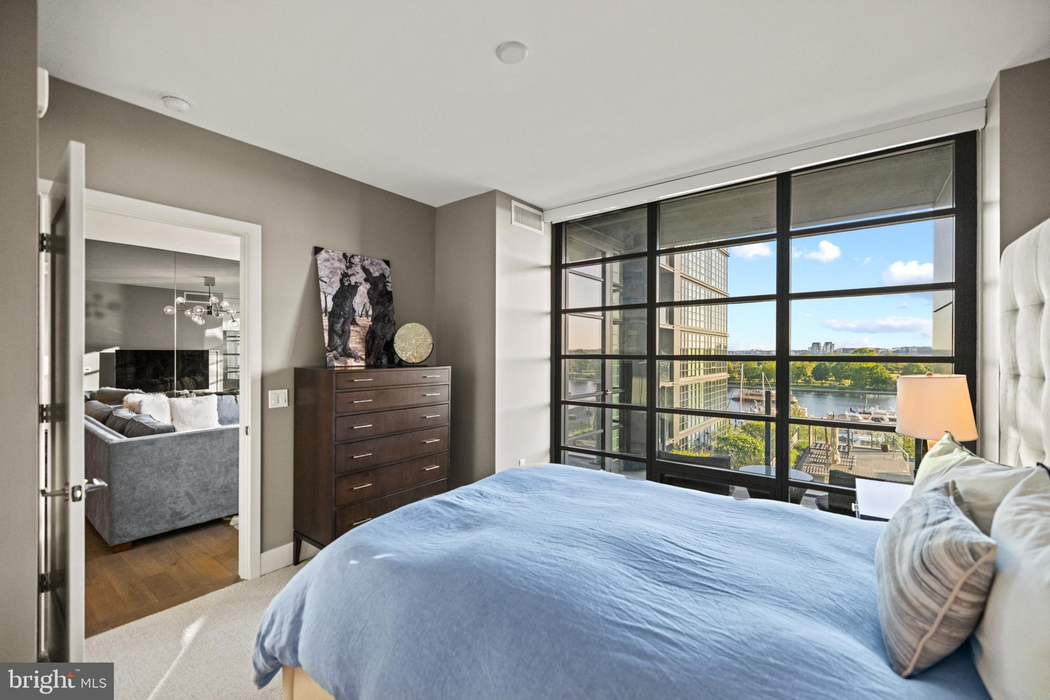 45 Sutton Square Southwest, Unit 503 Washington, DC 20024 - Photo 13 of 50 a bedroom with a bed and a large window