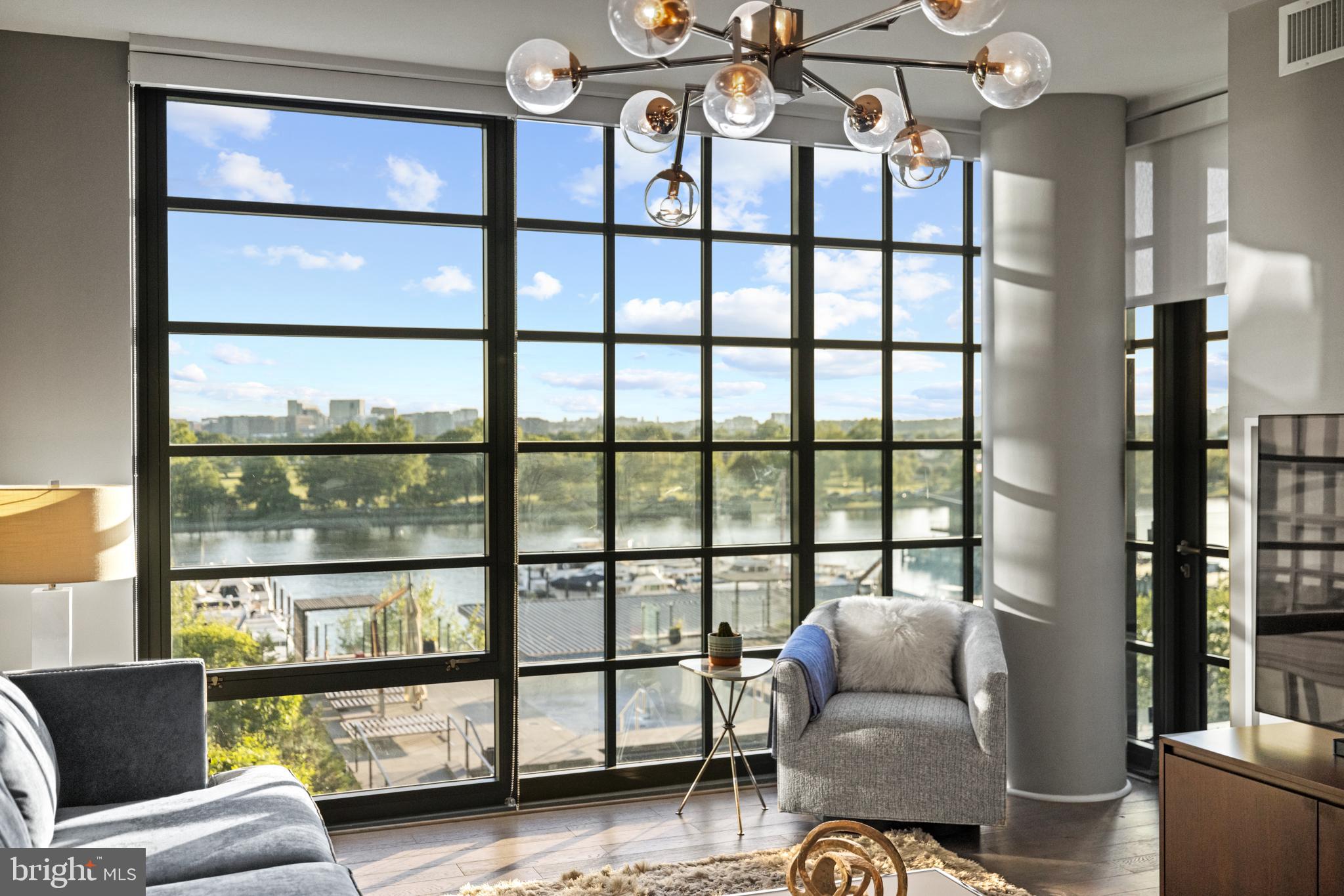 45 Sutton Square Southwest, Unit 503 Washington, DC 20024 - Photo 15 of 50 a living room with furniture and a large window
