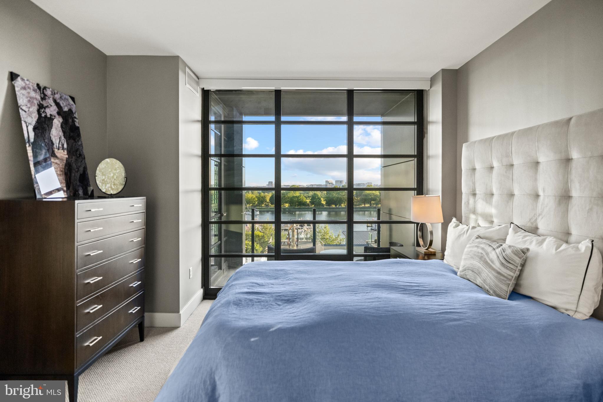 45 Sutton Square Southwest, Unit 503 Washington, DC 20024 - Photo 16 of 50 a large bed sitting in a bedroom next to a window