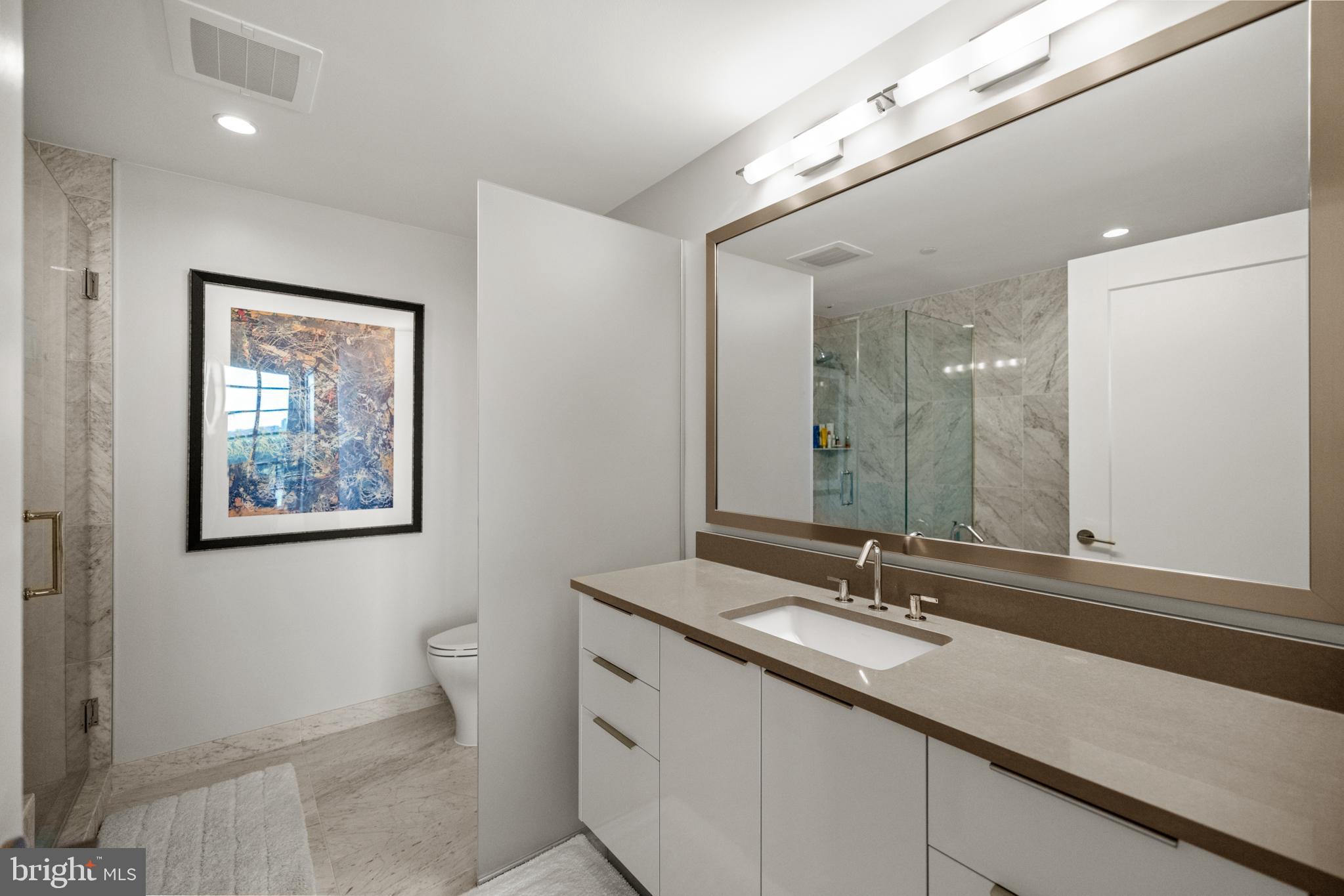 45 Sutton Square Southwest, Unit 503 Washington, DC 20024 - Photo 19 of 50 a bathroom with a double vanity sink and a mirror