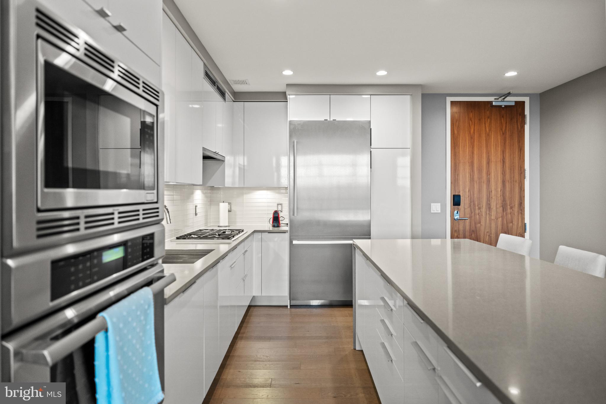 45 Sutton Square Southwest, Unit 503 Washington, DC 20024 - Photo 21 of 50 a kitchen with stainless steel appliances granite countertop a sink and a stove