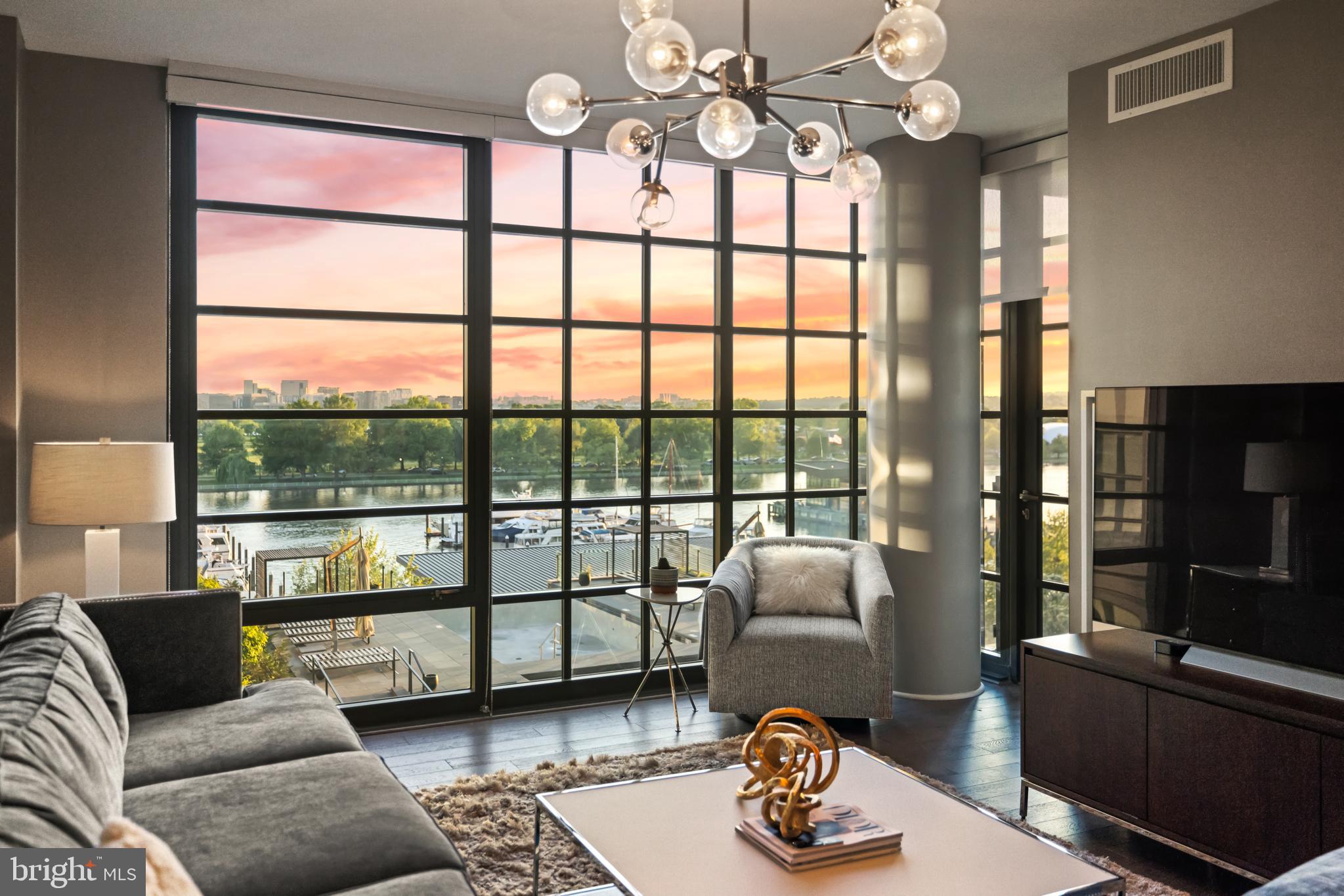 45 Sutton Square Southwest, Unit 503 Washington, DC 20024 - Photo 3 of 50 a living room with furniture and a floor to ceiling window
