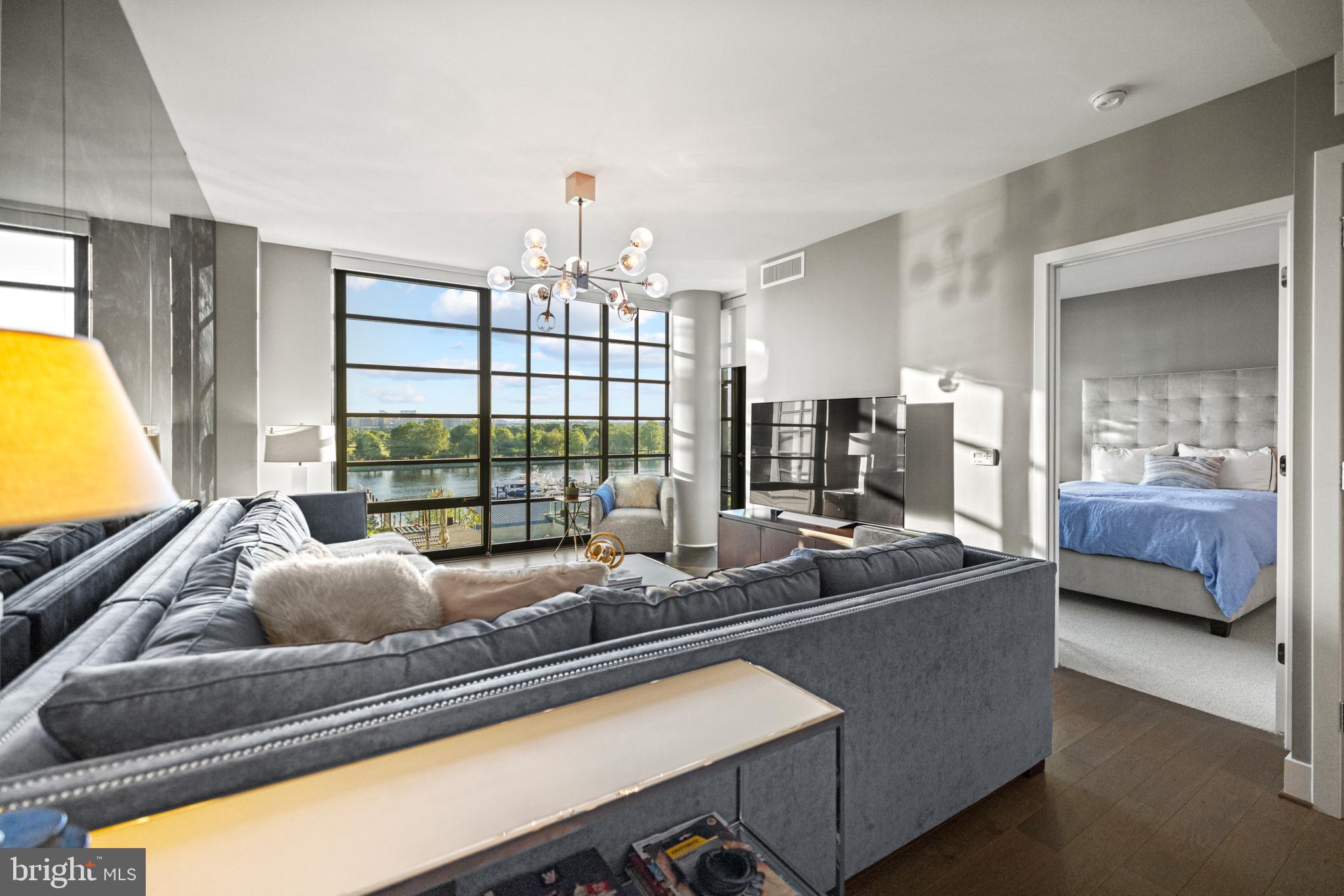 45 Sutton Square Southwest, Unit 503 Washington, DC 20024 - Photo 7 of 50 a living room with furniture and a large window