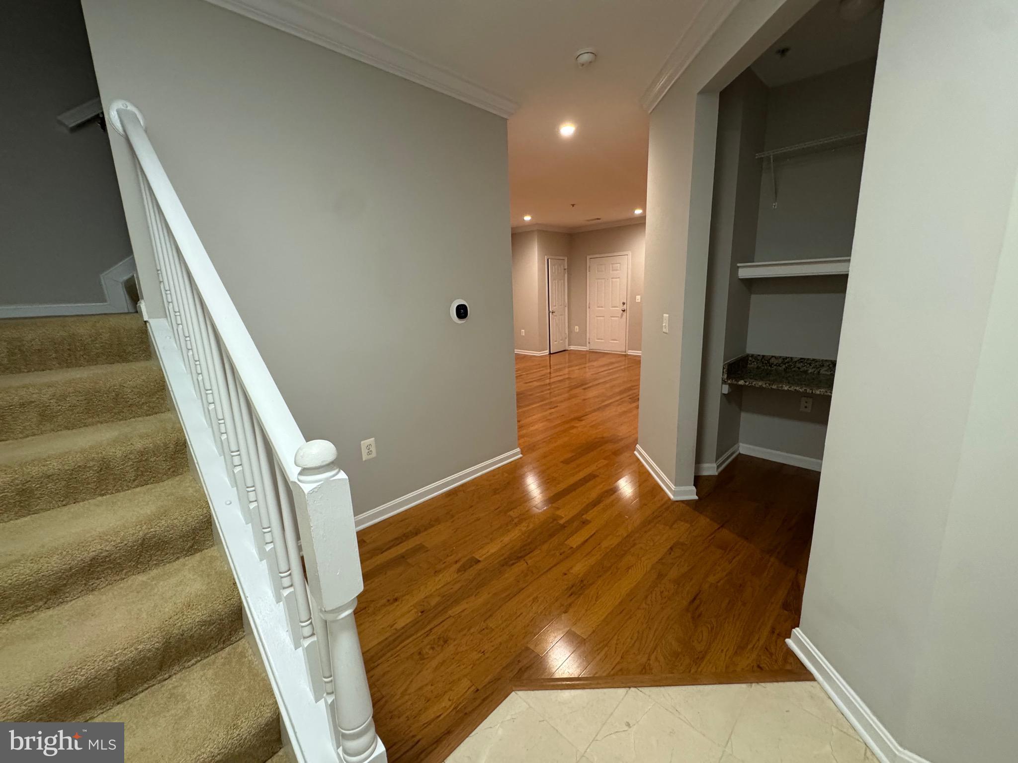 9486 Virginia Center Boulevard, Unit 114 Vienna, VA 22181 - Photo 14 of 41 a view of a hallway with wooden floor and entryway