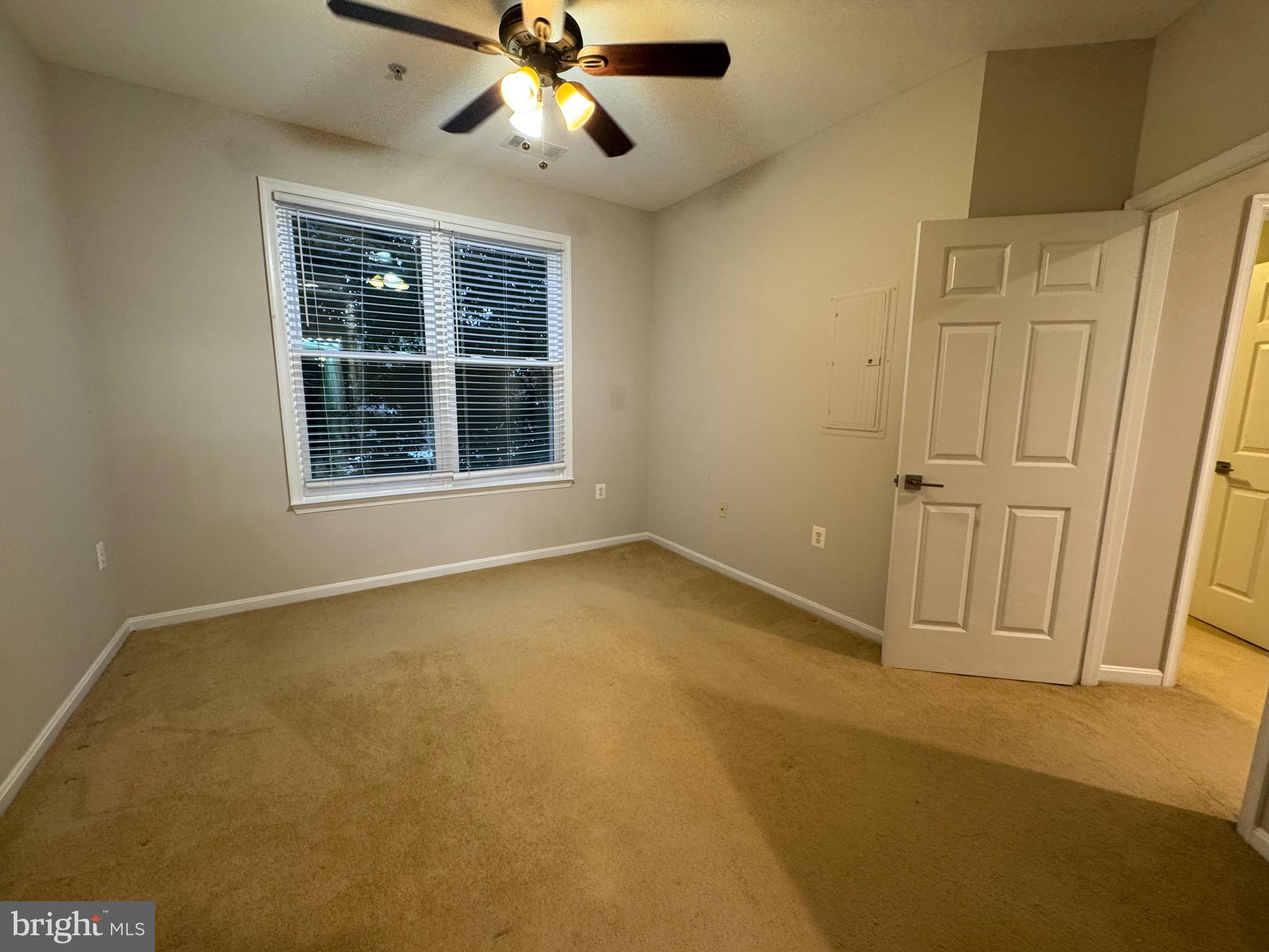 9486 Virginia Center Boulevard, Unit 114 Vienna, VA 22181 - Photo 16 of 41 an empty room with windows and fan
