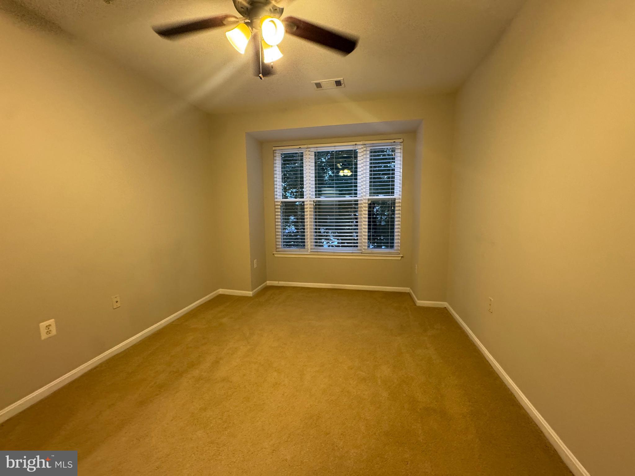9486 Virginia Center Boulevard, Unit 114 Vienna, VA 22181 - Photo 22 of 41 a view of an empty room with a window
