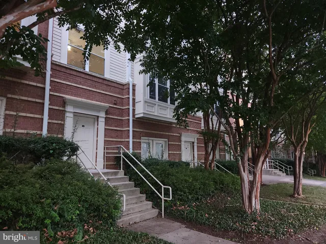 a front view of a house with a tree