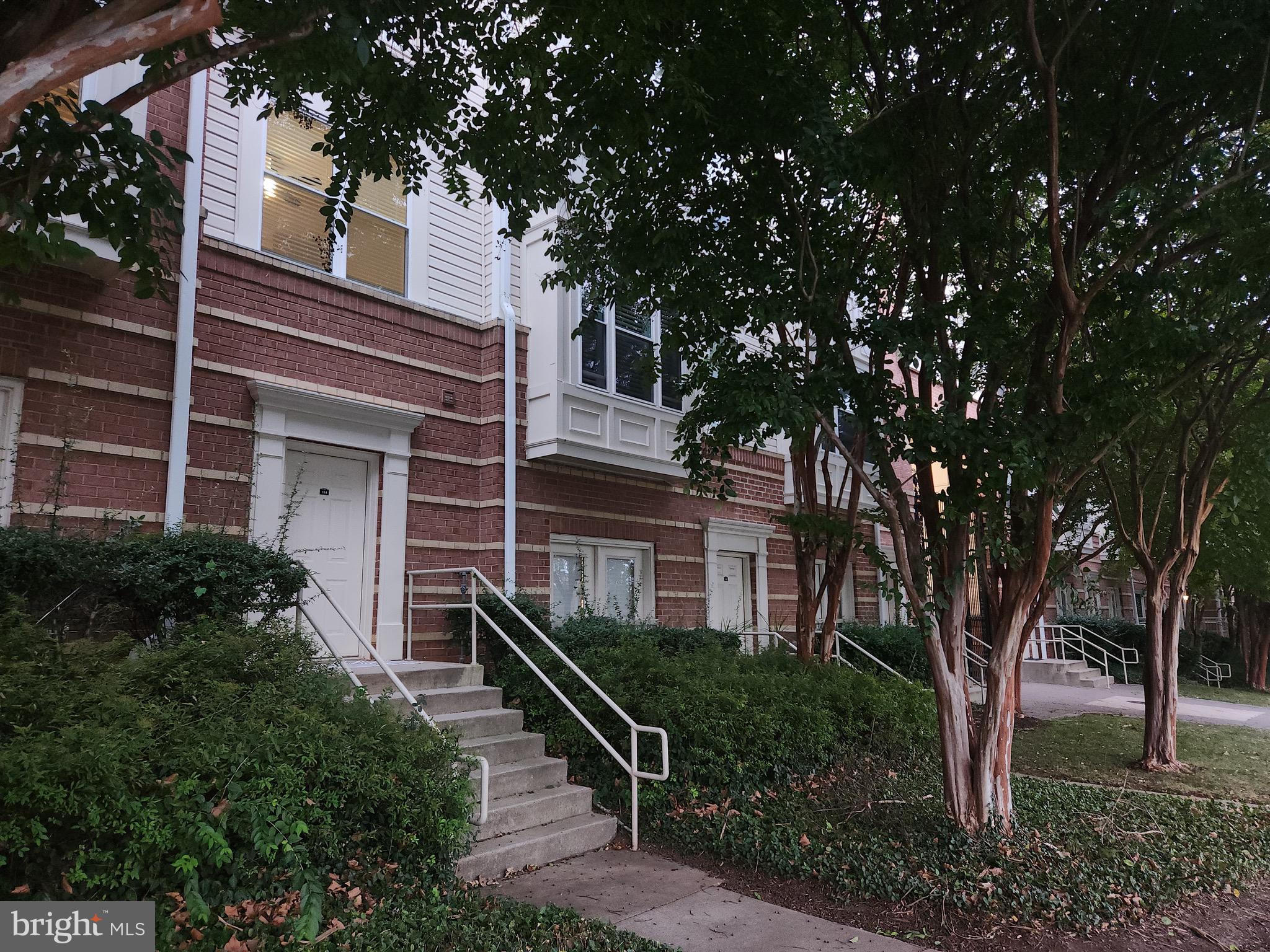 9486 Virginia Center Boulevard, Unit 114 Vienna, VA 22181 - Photo 3 of 41 a front view of a house with a tree