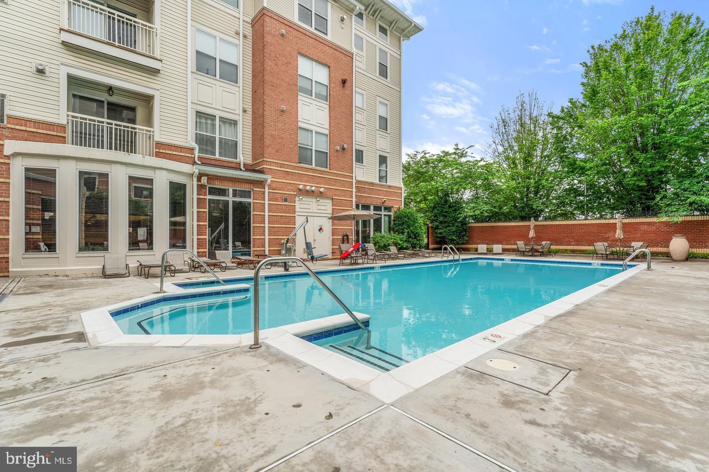 9486 Virginia Center Boulevard, Unit 114 Vienna, VA 22181 - Photo 33 of 41 a swimming pool with outdoor seating and yard