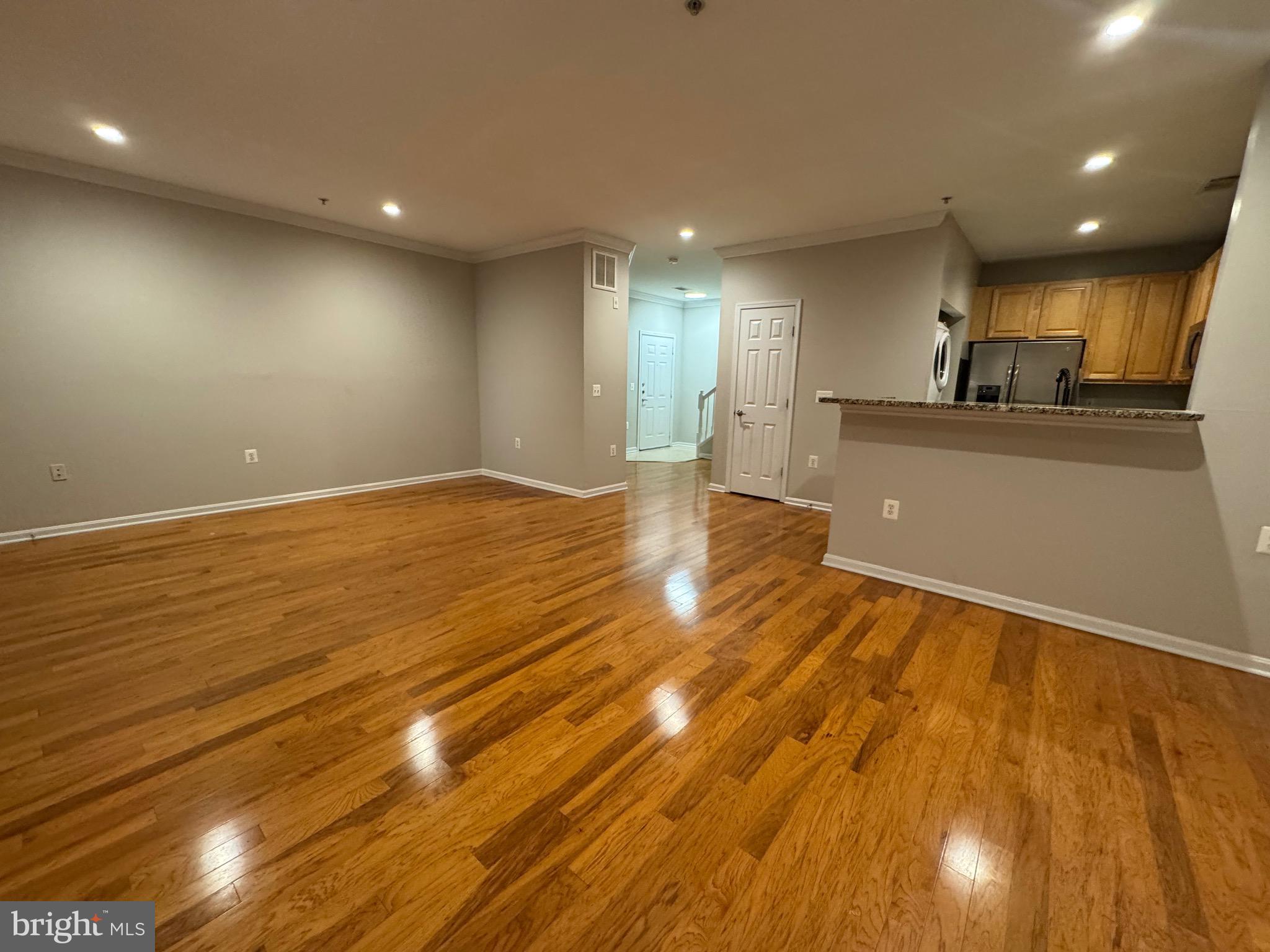 9486 Virginia Center Boulevard, Unit 114 Vienna, VA 22181 - Photo 7 of 41 a view of a big room with wooden floor and windows