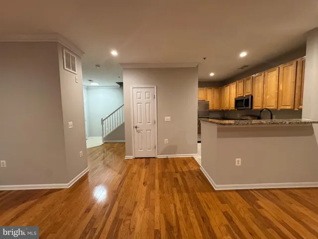 a view of a kitchen with a sink and cabinets