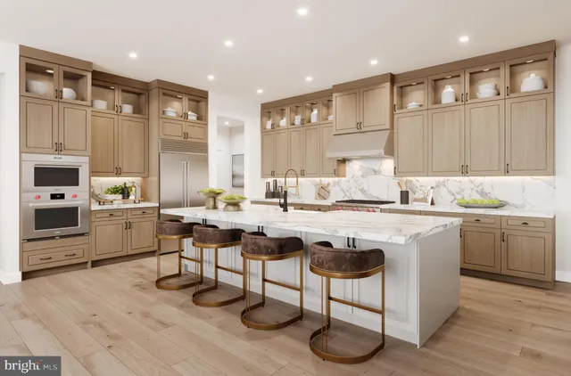 a kitchen with granite countertop a sink cabinets and wooden floor