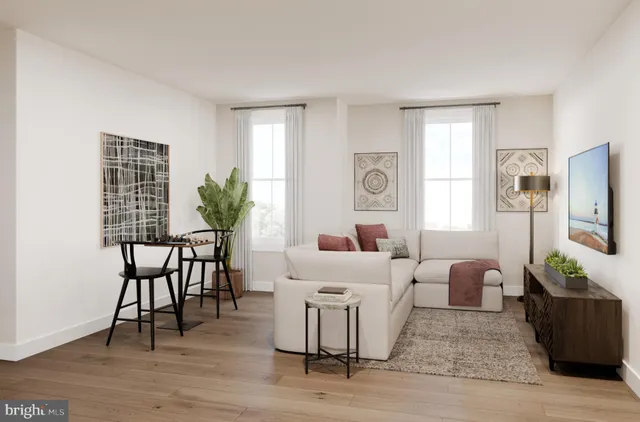 a living room with furniture potted plant and window