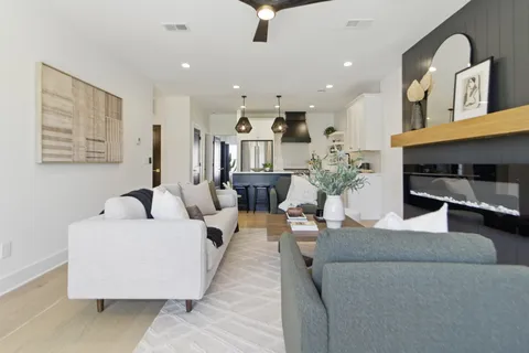 a living room with furniture and a chandelier