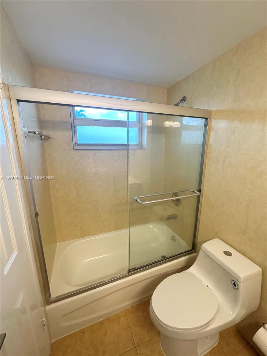 8400 Byron Avenue, Unit 2D Miami Beach, FL 33141 - Photo 13 of 21 a bathroom with a toilet and a shower
