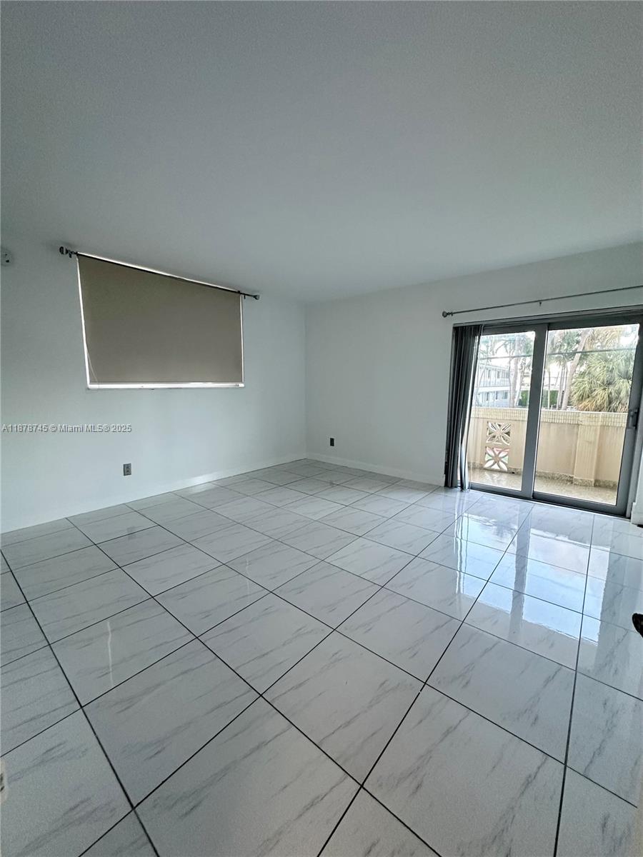8400 Byron Avenue, Unit 2D Miami Beach, FL 33141 - Photo 14 of 21 a view of an empty room and window