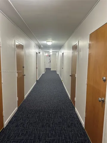 a view of hallway with stainless steel appliances
