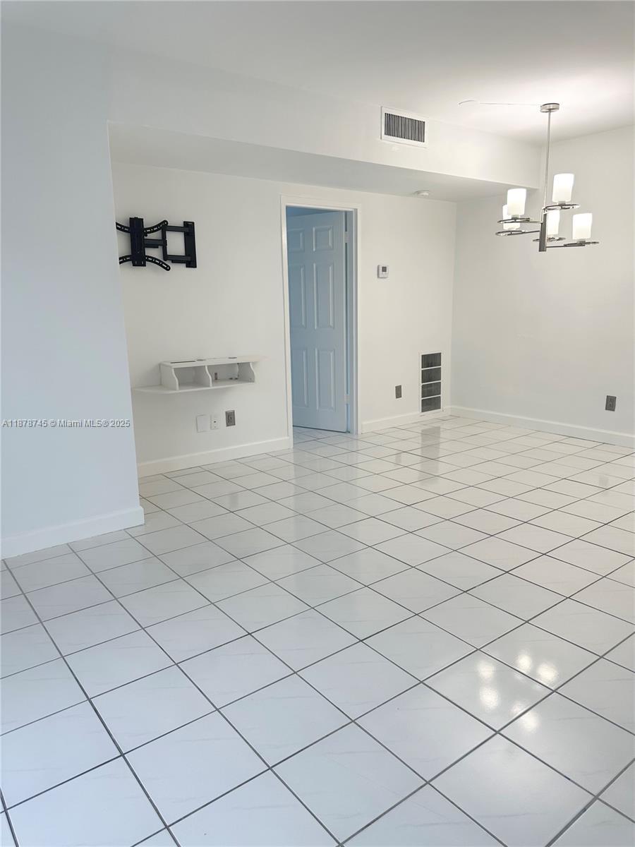 8400 Byron Avenue, Unit 2D Miami Beach, FL 33141 - Photo 7 of 21 a view of a livingroom with a furniture and chandelier