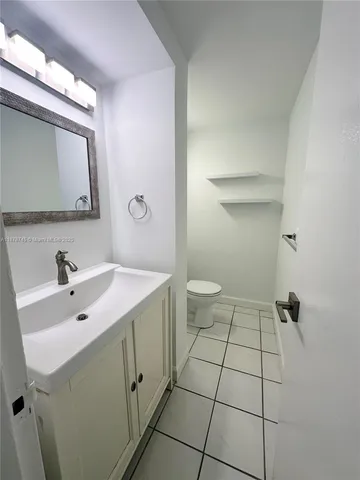 a bathroom with a sink toilet and mirror