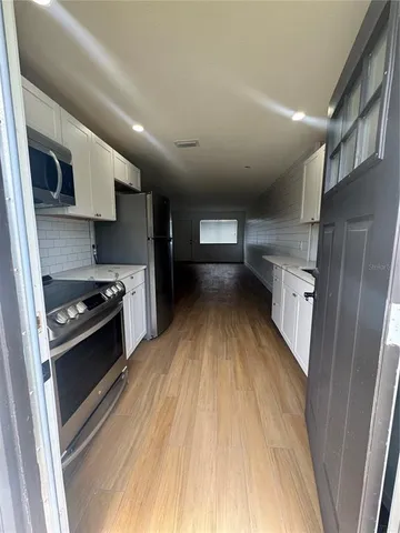 a kitchen with a stove and a microwave
